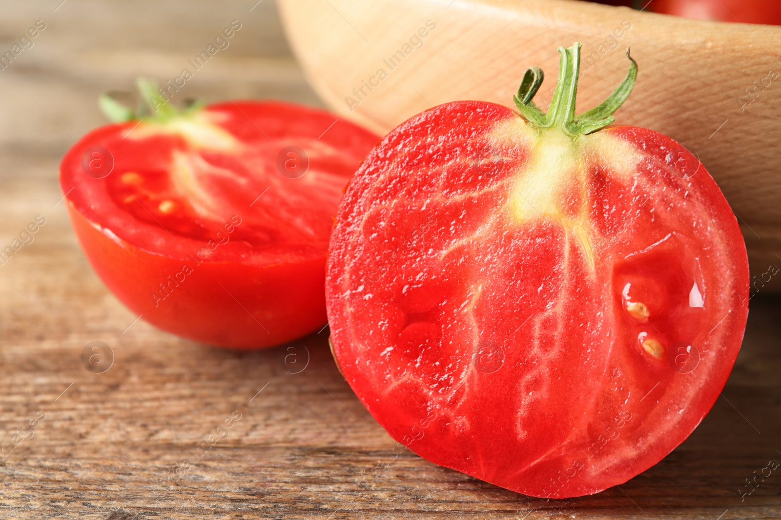 Photo of Fresh ripe tomatoes on wooden table, closeup