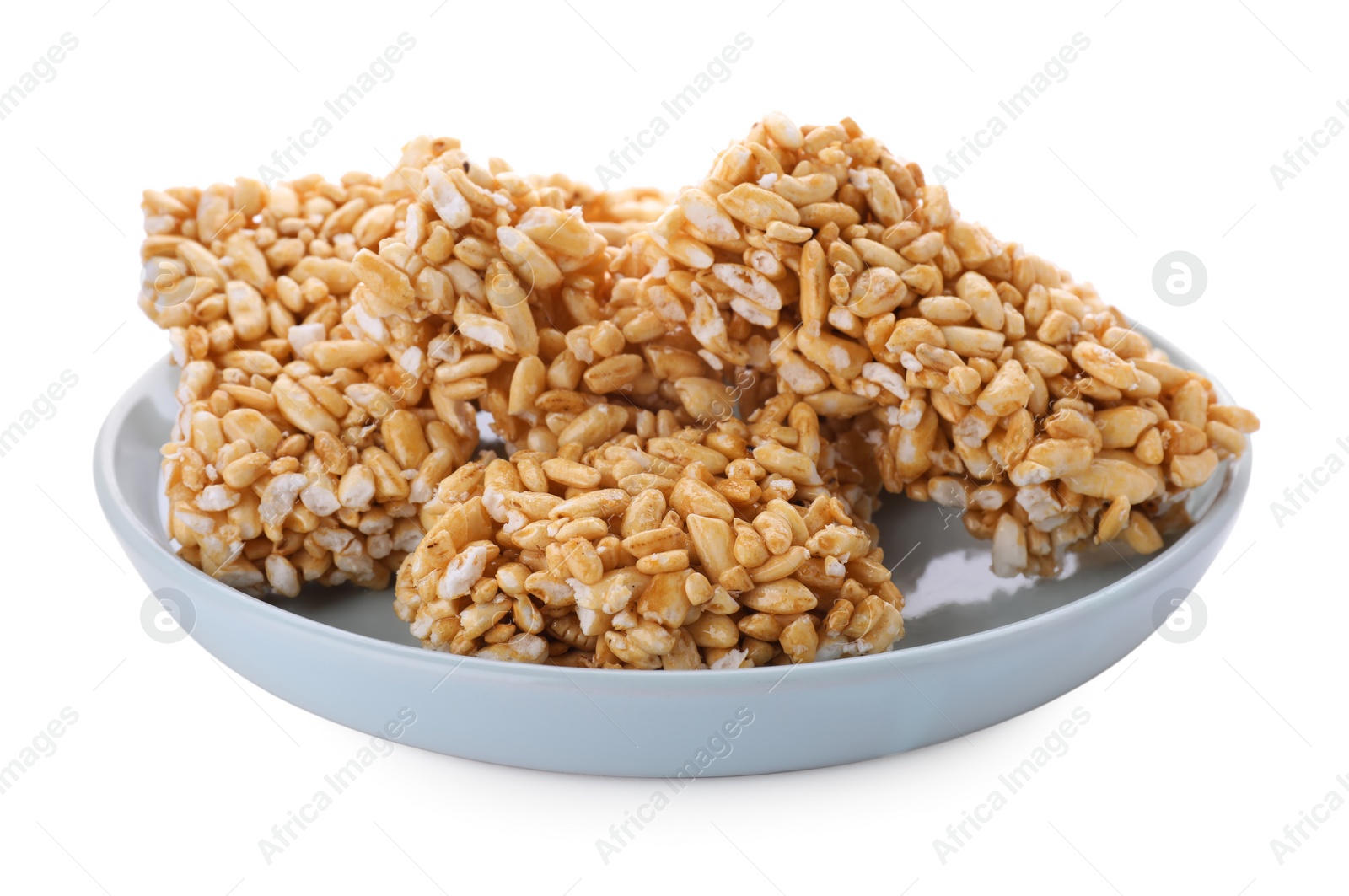 Photo of Plate with puffed rice bars (kozinaki) on white background