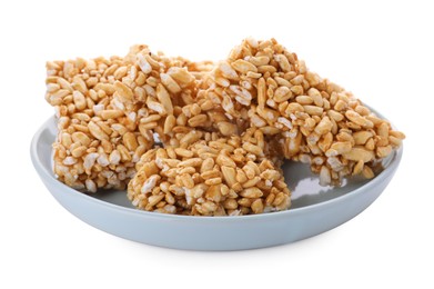 Photo of Plate with puffed rice bars (kozinaki) on white background