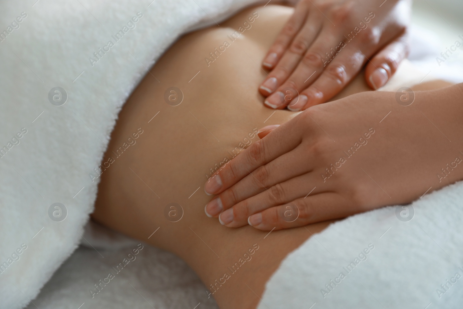 Photo of Woman receiving professional belly massage, closeup view