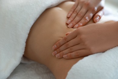 Woman receiving professional belly massage, closeup view