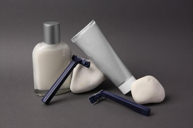 Photo of Different men's shaving accessories on dark grey background