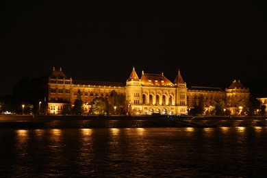 Photo of BUDAPEST, HUNGARY - APRIL 27, 2019: Beautiful night cityscape with illuminated University of Technology and Economics