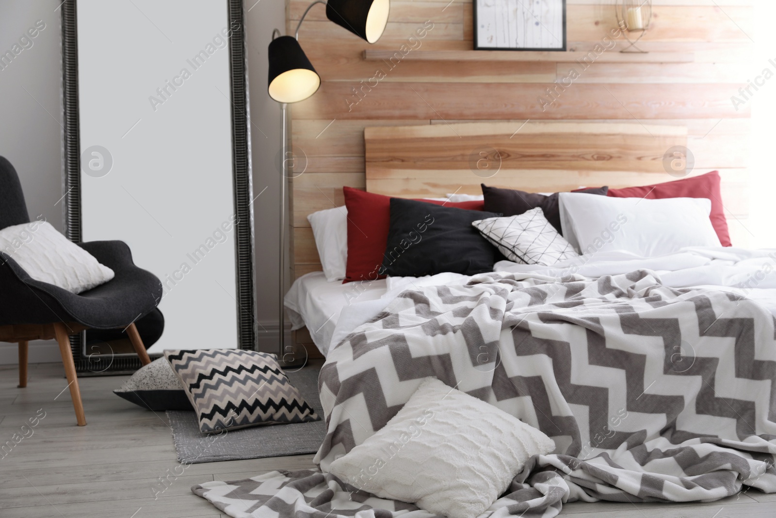 Photo of Different pillows on bed in room. Idea for interior decor