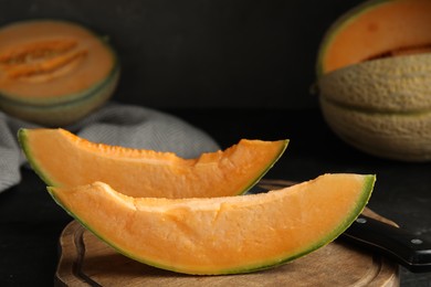 Slices of tasty fresh melon on wooden board, closeup