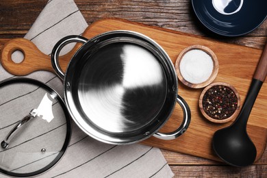 Photo of Flat lay composition of empty pot with lid on wooden table