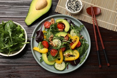 Balanced diet and vegetarian foods. Plate with different delicious products on wooden table, flat lay