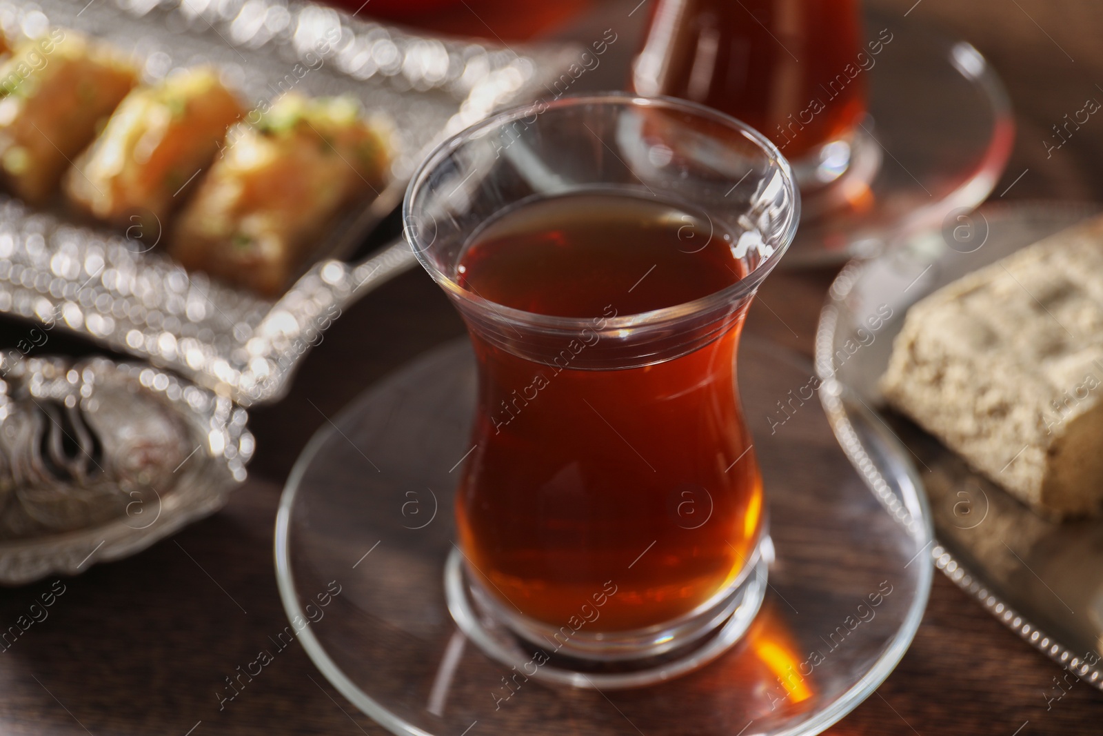 Photo of Traditional Turkish tea in glass on table, closeup