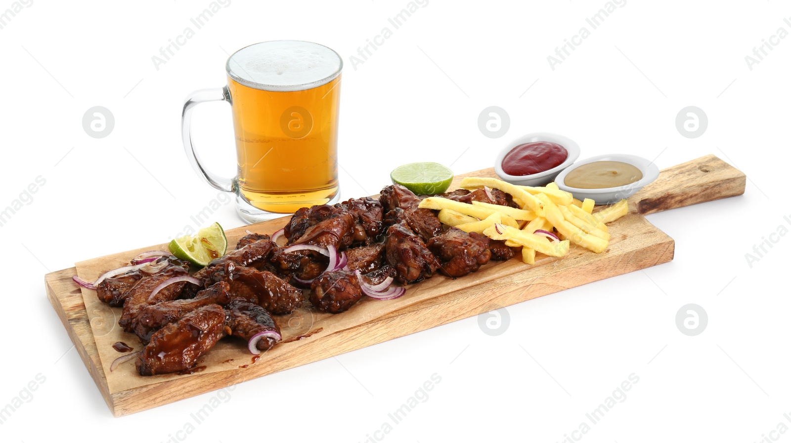 Photo of Wooden board with tasty roasted chicken wings, french fries, mug of beer and sauces isolated on white