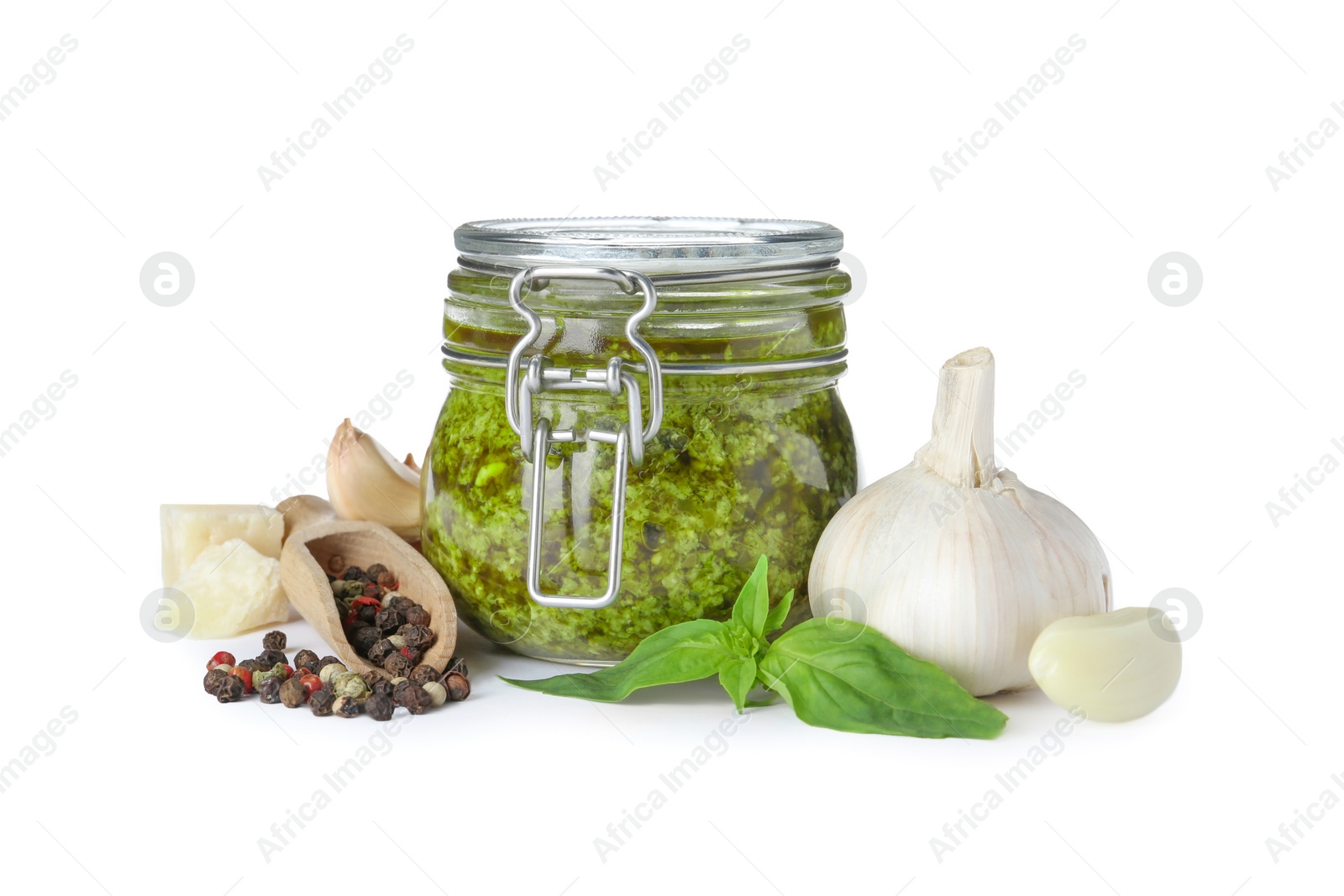 Photo of Composition with jar of tasty pesto sauce isolated on white