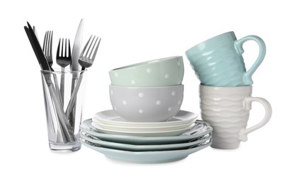 Set of beautiful ceramic dishware, glass and cutlery isolated on white