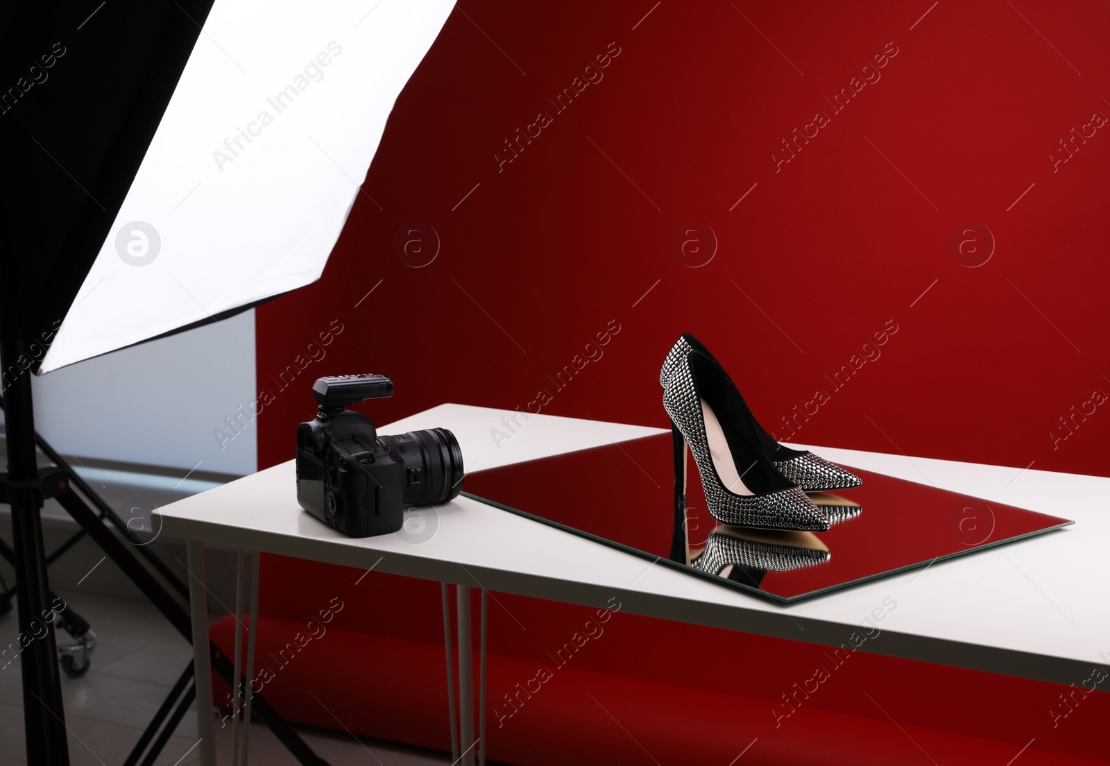 Photo of Professional photography equipment prepared for shooting stylish shoes in studio