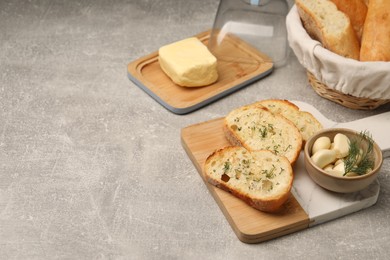 Photo of Tasty baguette with garlic and dill served on light grey table, space for text