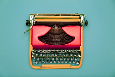 Image of Copywriter. Vintage typewriter on turquoise background, top view