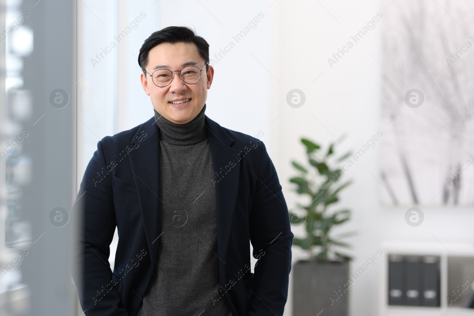 Photo of Portrait of smiling businessman in office. Space for text