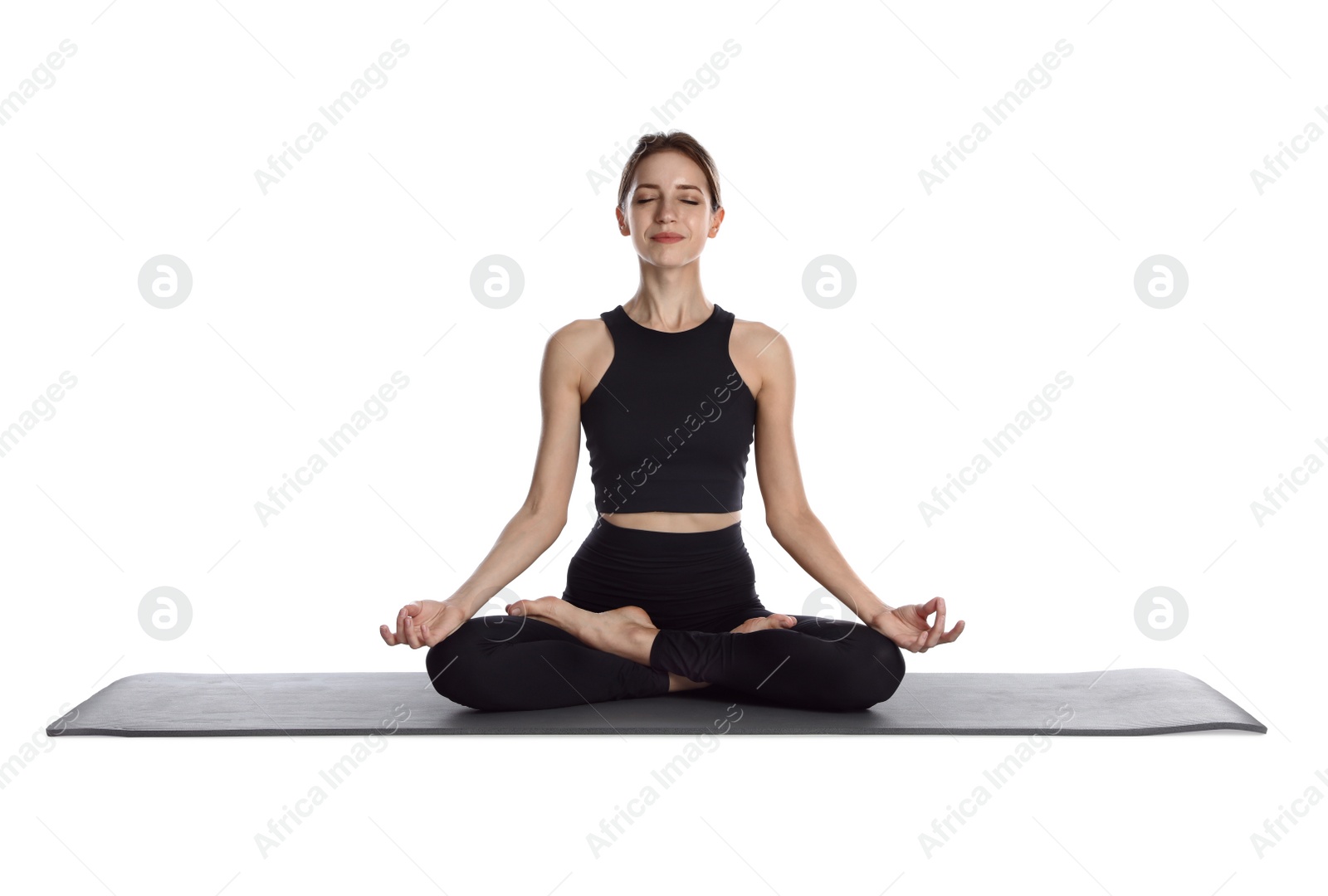 Photo of Young woman in sportswear practicing yoga on white background