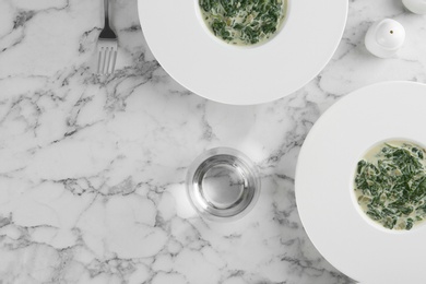 Photo of Tasty spinach dip on white marble table, flat lay