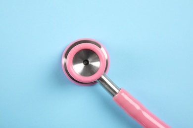 Photo of Stethoscope on color background, top view. Medical tool