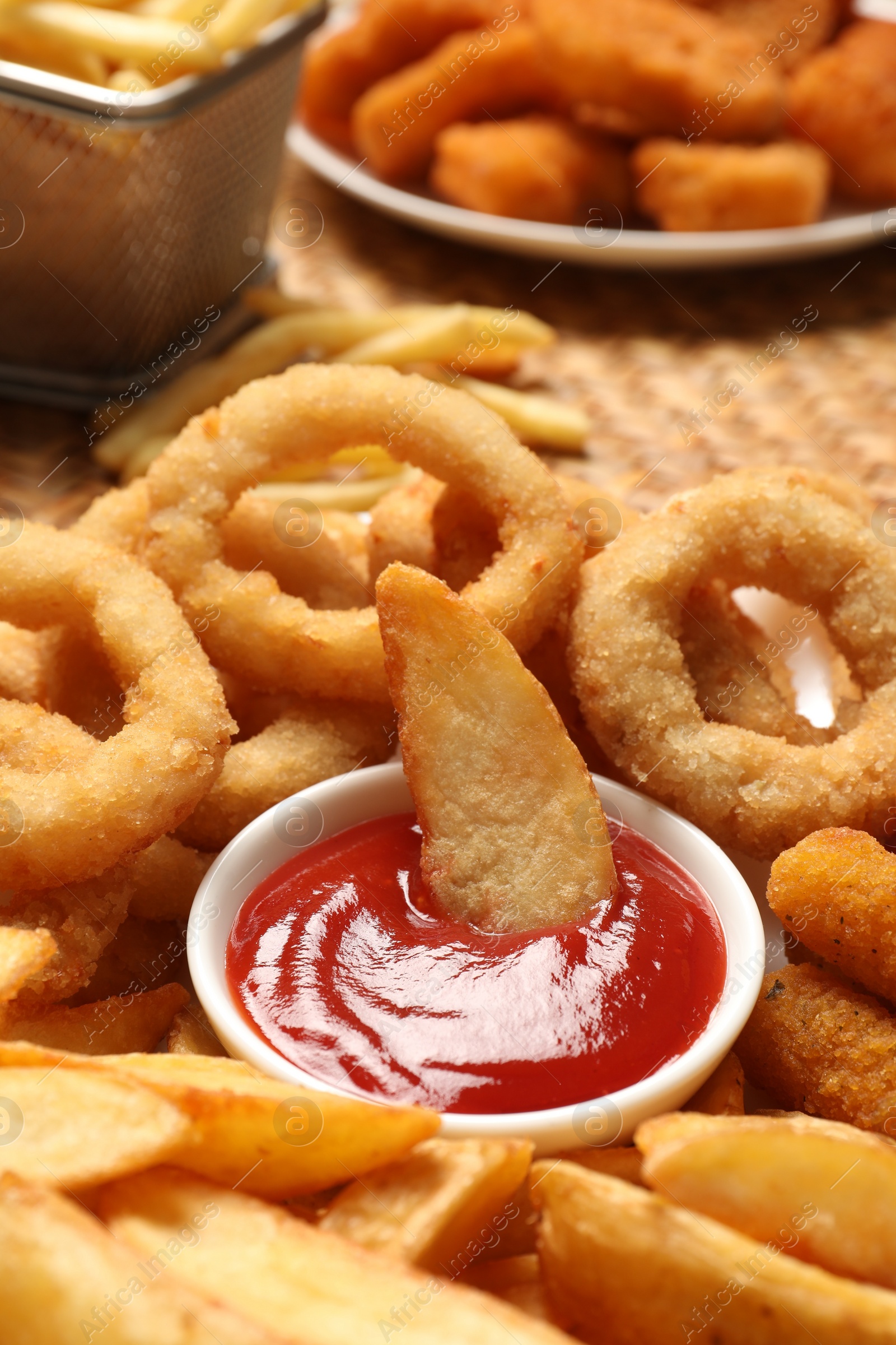 Photo of Different snacks and tasty ketchup on table, closeup