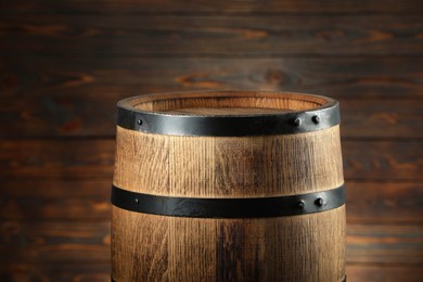 Photo of One wooden barrel near wall, closeup view
