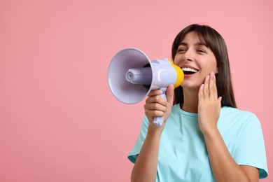 Photo of Special promotion. Woman shouting in megaphone on pink background, space for text