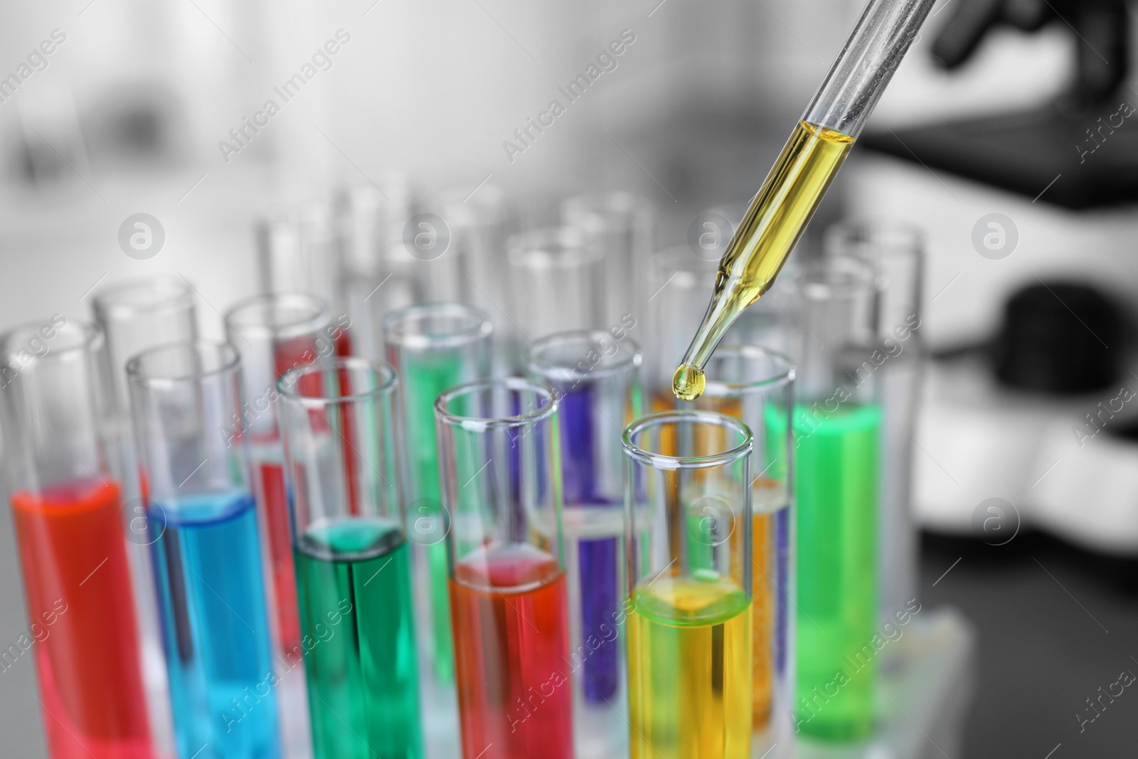 Photo of Laboratory test tubes and pipette, closeup. Solution chemistry