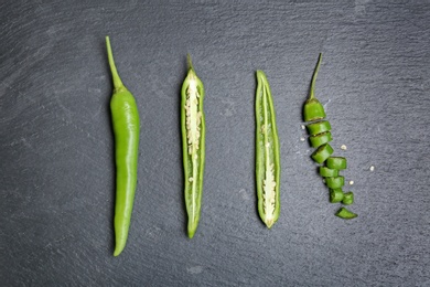 Flat lay composition with chili peppers on grey background