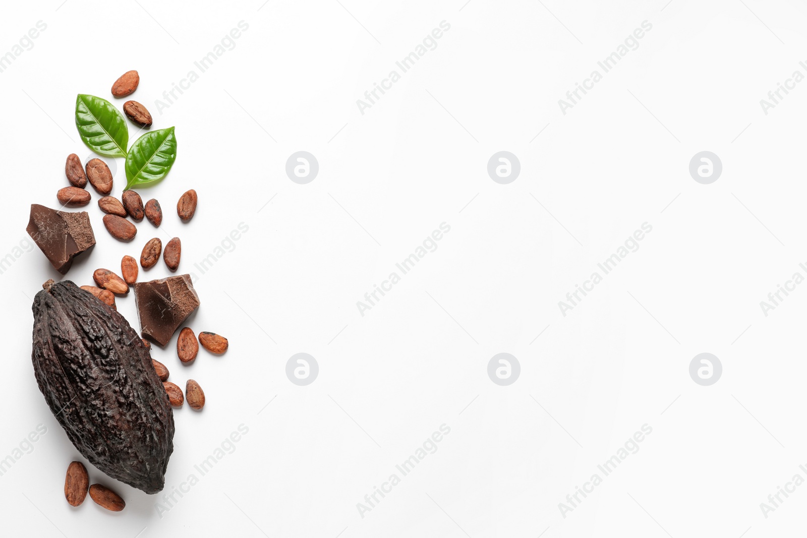 Photo of Cocoa pod with beans and chocolate pieces on white background, top view