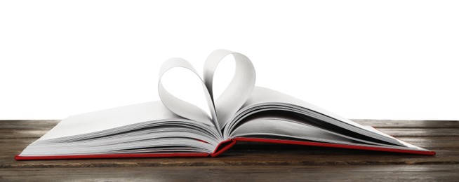 Photo of Open book with pages folded in heart on wooden table against white background