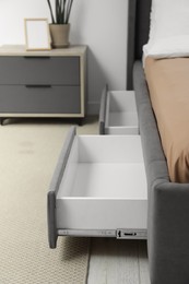 Photo of Storage drawers for bedding under modern bed in room