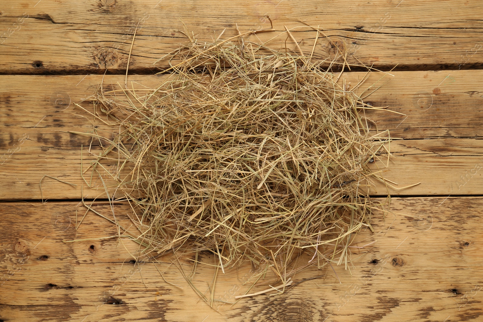 Photo of Dried hay on wooden background, top view