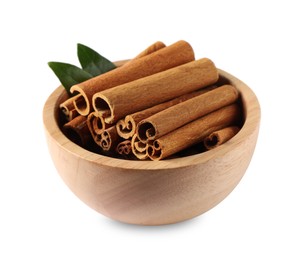 Cinnamon sticks and green leaves in bowl isolated on white