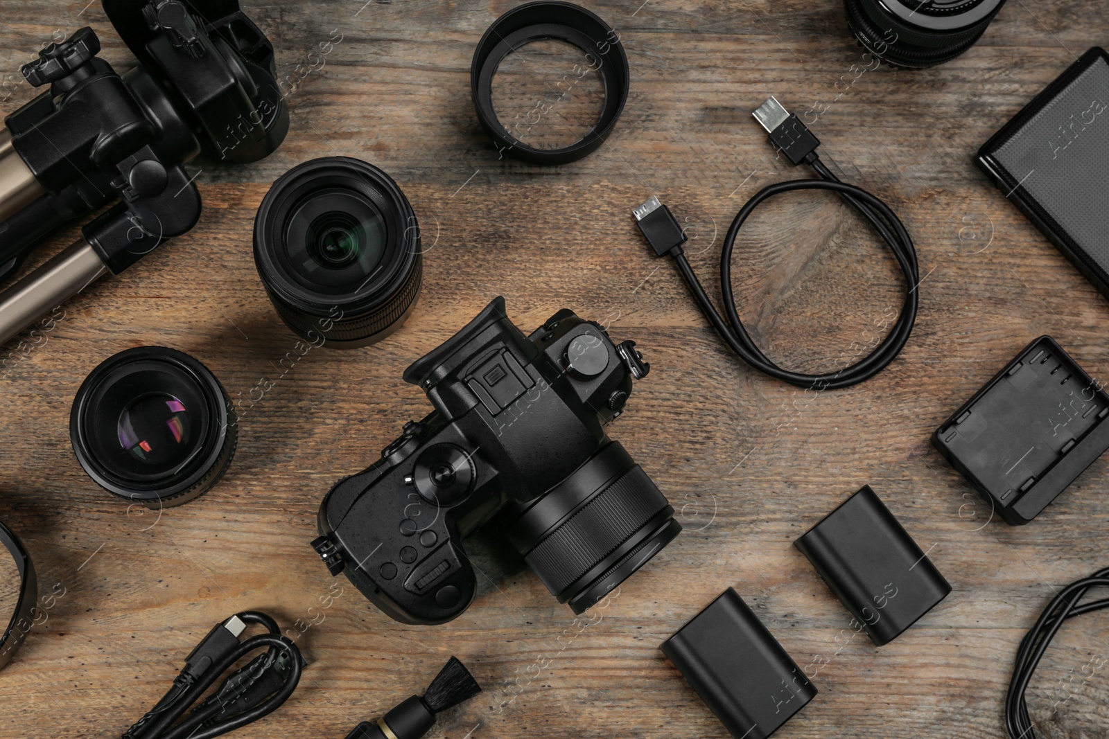 Photo of Flat lay composition with camera and video production equipment on wooden table