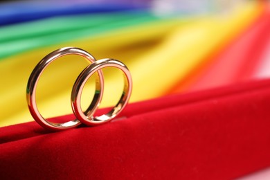 Photo of Wedding rings on rainbow LGBT flag, closeup