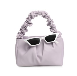 Photo of Stylish woman's bag and sunglasses isolated on white