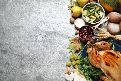 Flat lay composition with delicious turkey on grey background, space for text. Happy Thanksgiving day