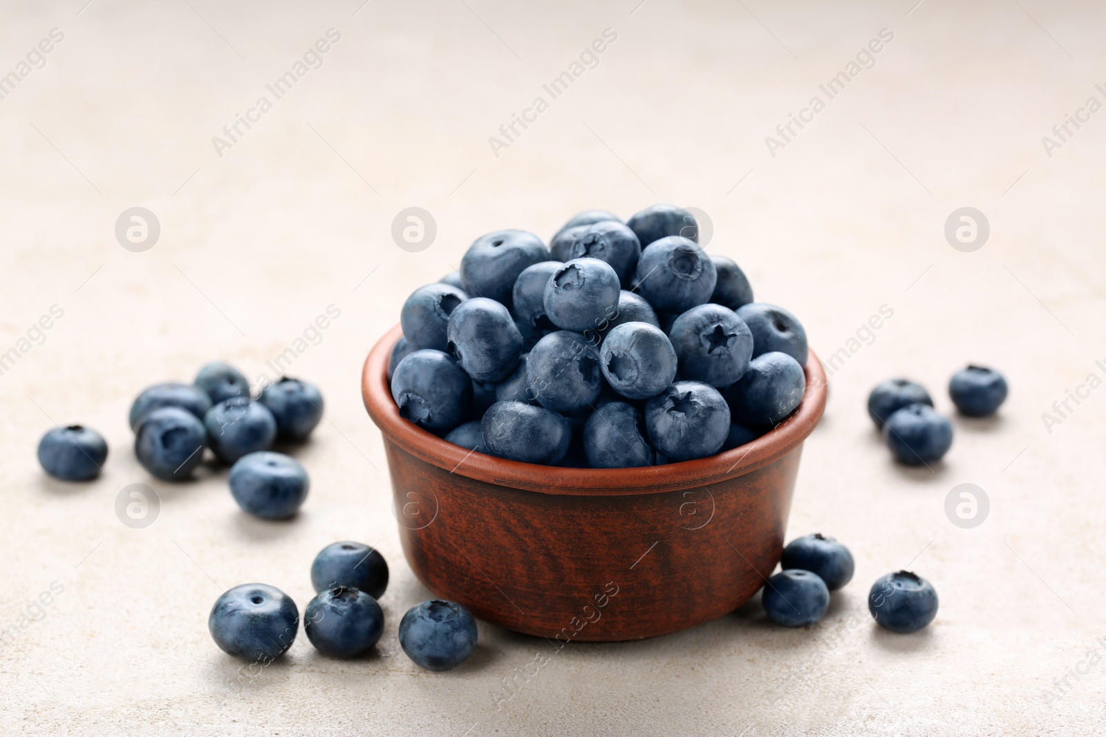 Photo of Tasty fresh blueberries on light table, closeup