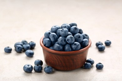 Photo of Tasty fresh blueberries on light table, closeup