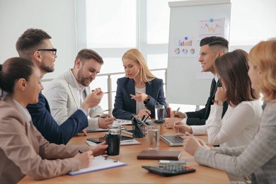 Photo of Businesspeople having meeting in office. Management consulting