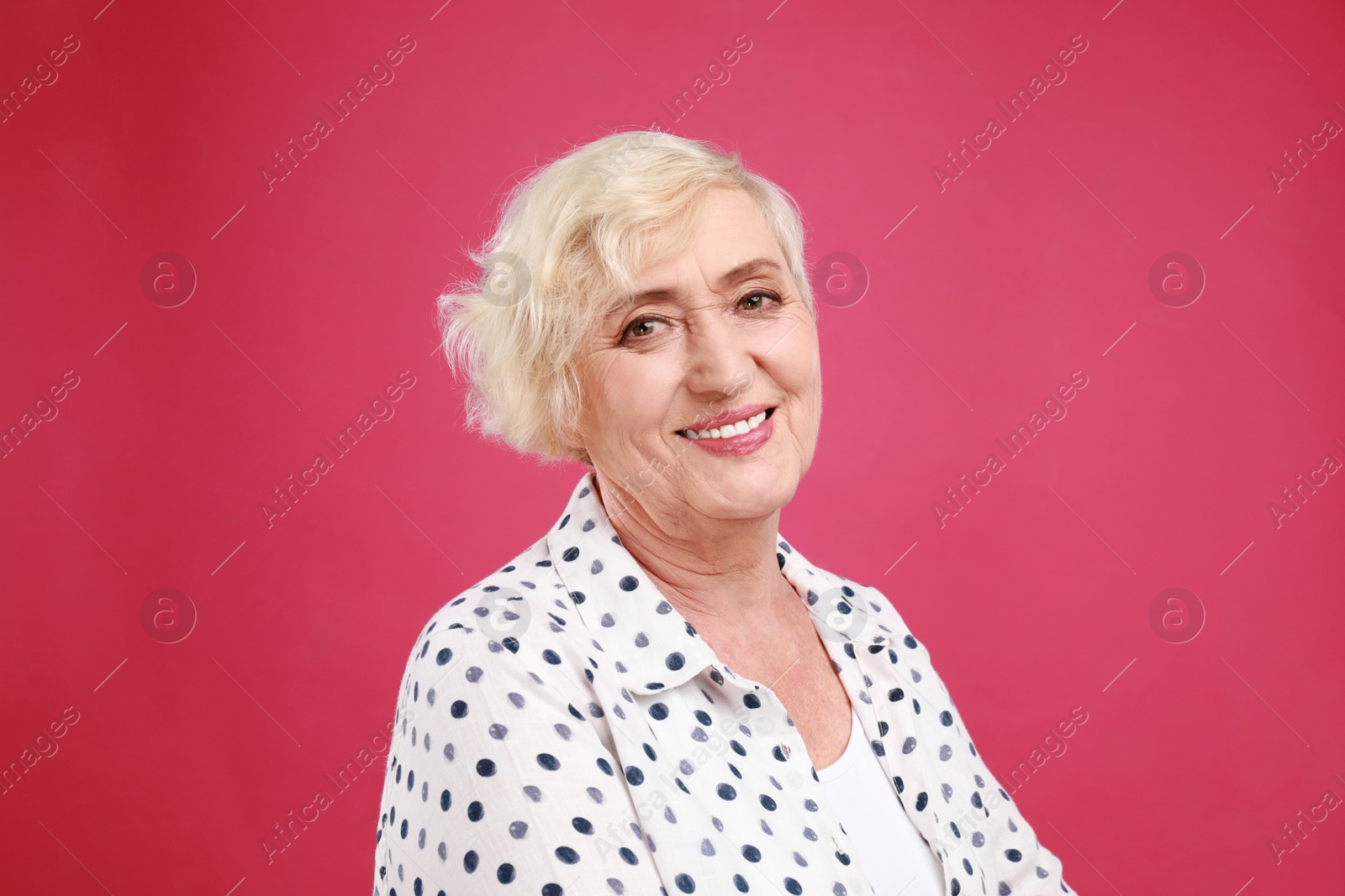 Photo of Senior woman in casual outfit on crimson background