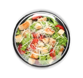 Delicious fresh salad in plastic container with lid on white background, top view