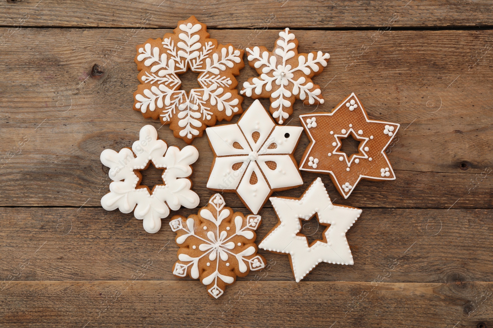 Photo of Many different delicious Christmas cookies on wooden table, flat lay