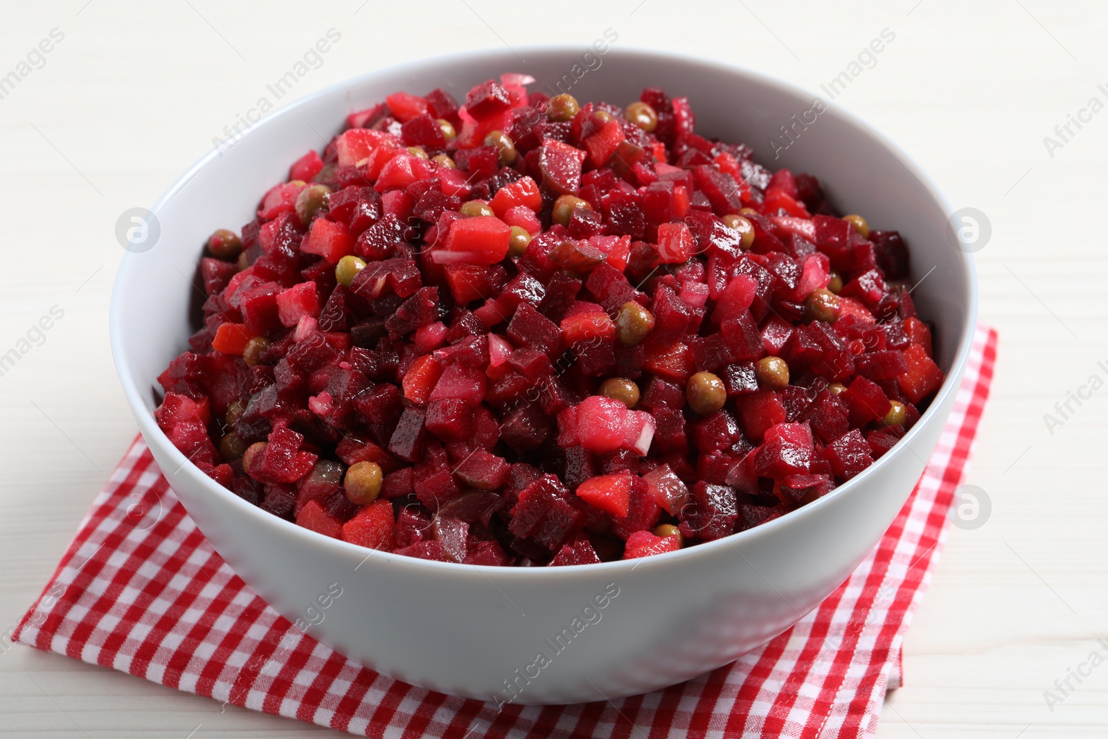 Photo of Delicious fresh vinaigrette salad on white table, closeup