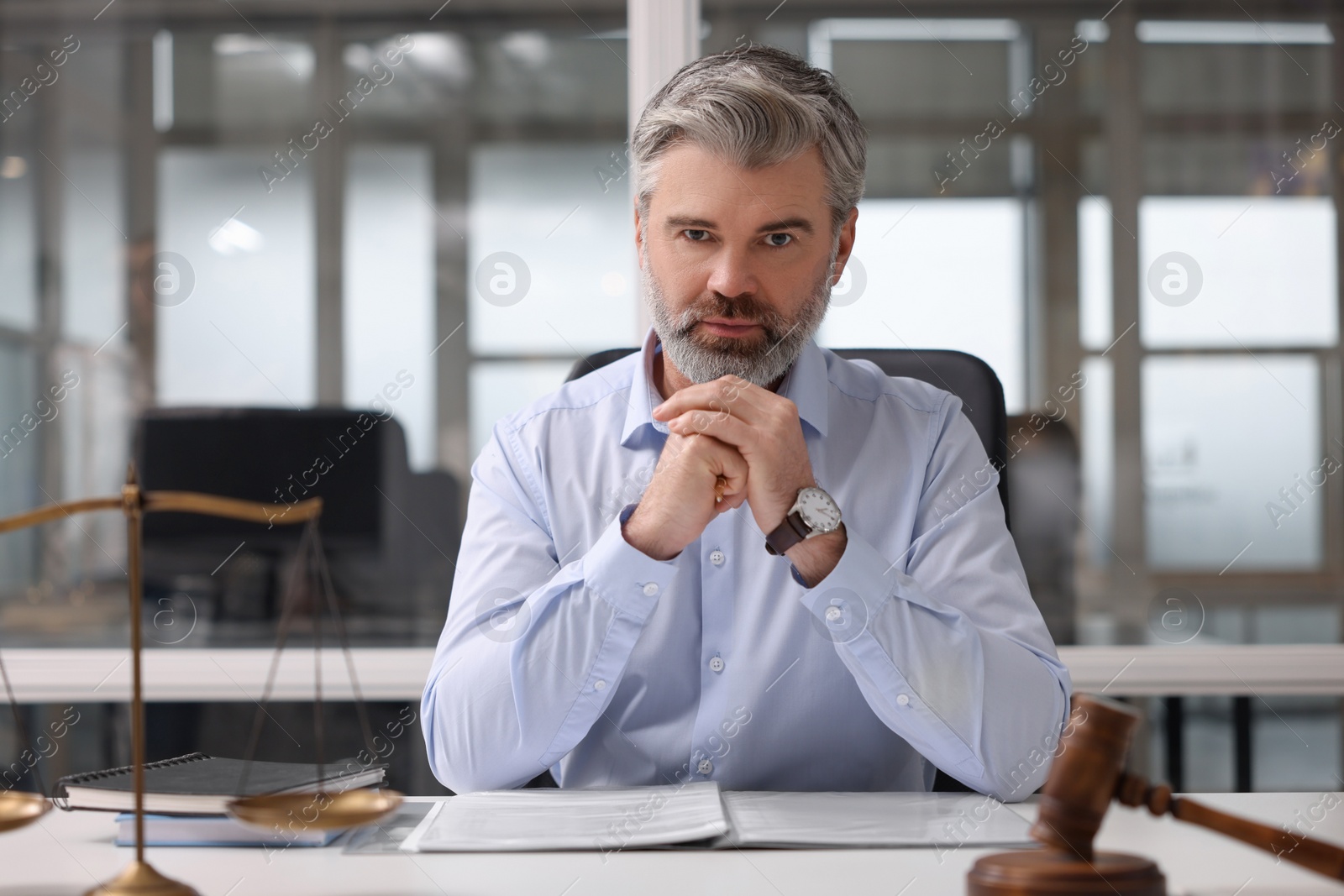 Photo of Portrait of handsome lawyer at table in office