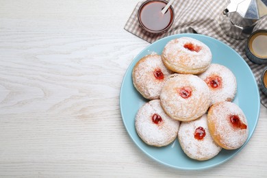 Photo of Delicious jam donuts served with coffee on white wooden table, flat lay. Space for text