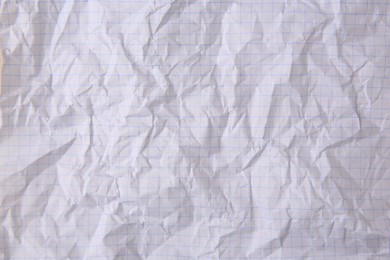 Photo of Sheet of crumpled checkered paper as background, top view