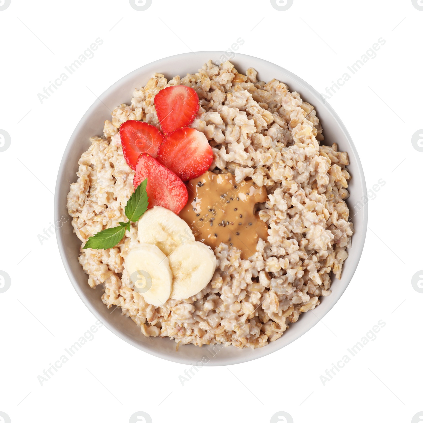 Photo of Tasty boiled oatmeal with strawberry, banana, chia seeds and peanut butter in bowl isolated on white, top view