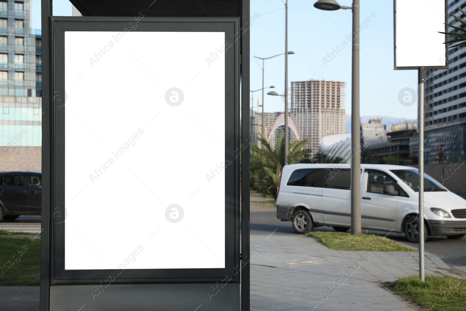 Image of Bus stop with empty signboard in city. Mock-up for design