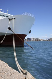 Photo of Modern ferry moored in sea port on sunny day