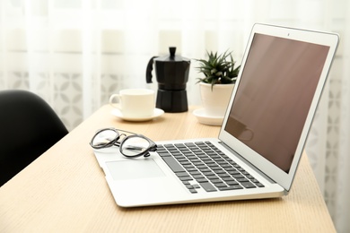 Photo of Cozy blogger workplace with laptop at home